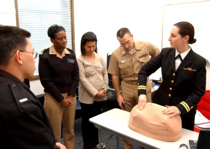 US Navy 040121-N-0000W-123 Using a model torso, Labor and Deliver Nurse Lt. Kristin Berndt, assigned to U.S. Naval Hospital Okinawa, helps nurses in Yokosuka learn advanced techniques in fetal monitoring