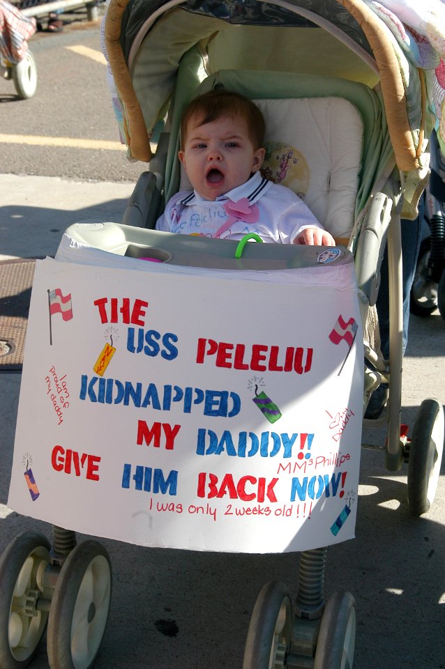 US Navy 040309-N-0000X-001 An inpatient child waits for his father Machinist's Mate 3rd Class James Phillips to arrive home aboard the amphibious assault ship USS Peleliu (LHA 5)