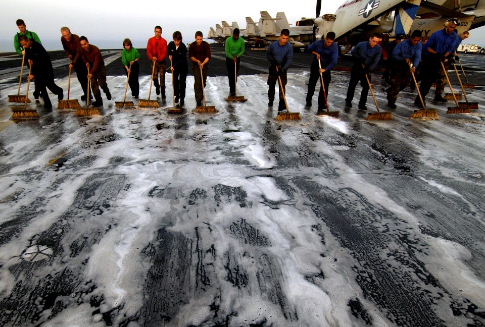 US Navy 040327-N-5319A-003 Flight deck crewmen aboard USS George Washington (CVN 73) participate in a Scrub Ex of the flight deck during a no-fly day
