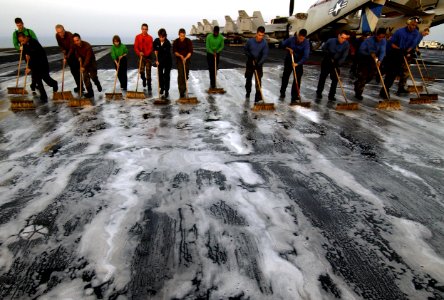 US Navy 040327-N-5319A-003 Flight deck crewmen aboard USS George Washington (CVN 73) participate in a Scrub Ex of the flight deck during a no-fly day