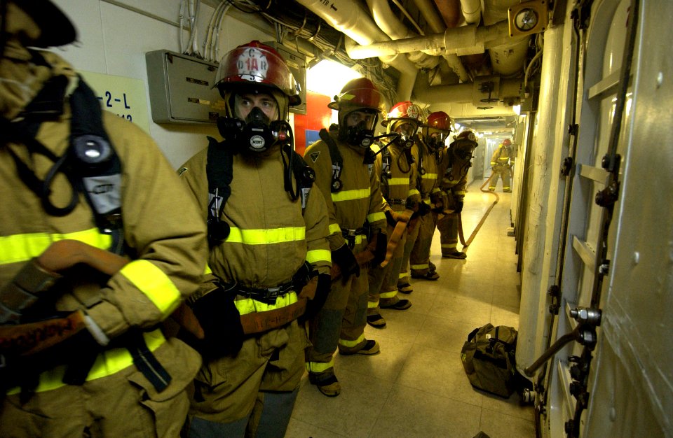 US Navy 040309-N-5319A-007 A fire fighting hose team investigates smoke on the forward mess decks during an Improvised Explosive Device (IED) and Mass Causality exercise