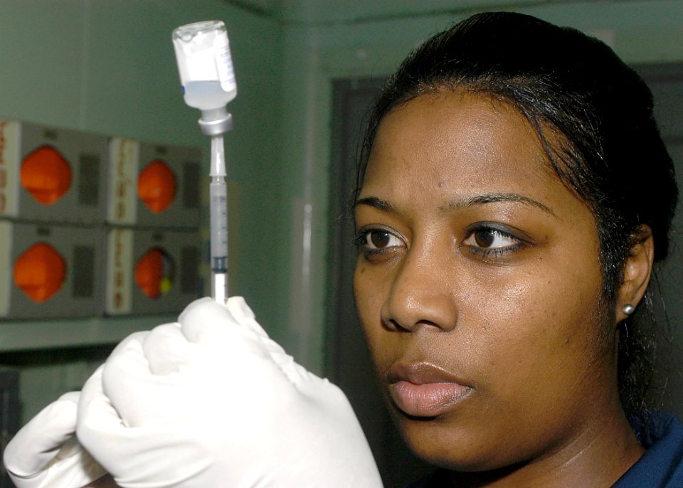 US Navy 040122-N-6653C-001 Hospital Corpsman Antoinette Johnson from New Orleans, La., draws a shot of the anthrax vaccine to be administered to crewmembers aboard USS George Washington (CVN 73)
