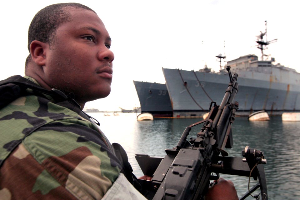 US Navy 040329-N-3228G-002 Master-at-Arms Seaman Ray Cowan, assigned to Naval Station Pearl Harbor Security, mans an M-60 machine gun aboard a 28-foot Sea Ark patrol boat
