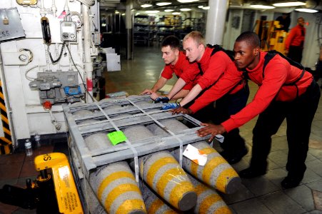US Navy 110721-N-AU622-082 Sailors move ordnance on the mess decks of USS Dwight D. Eisenhower (CVN 69) during an ammunition onload