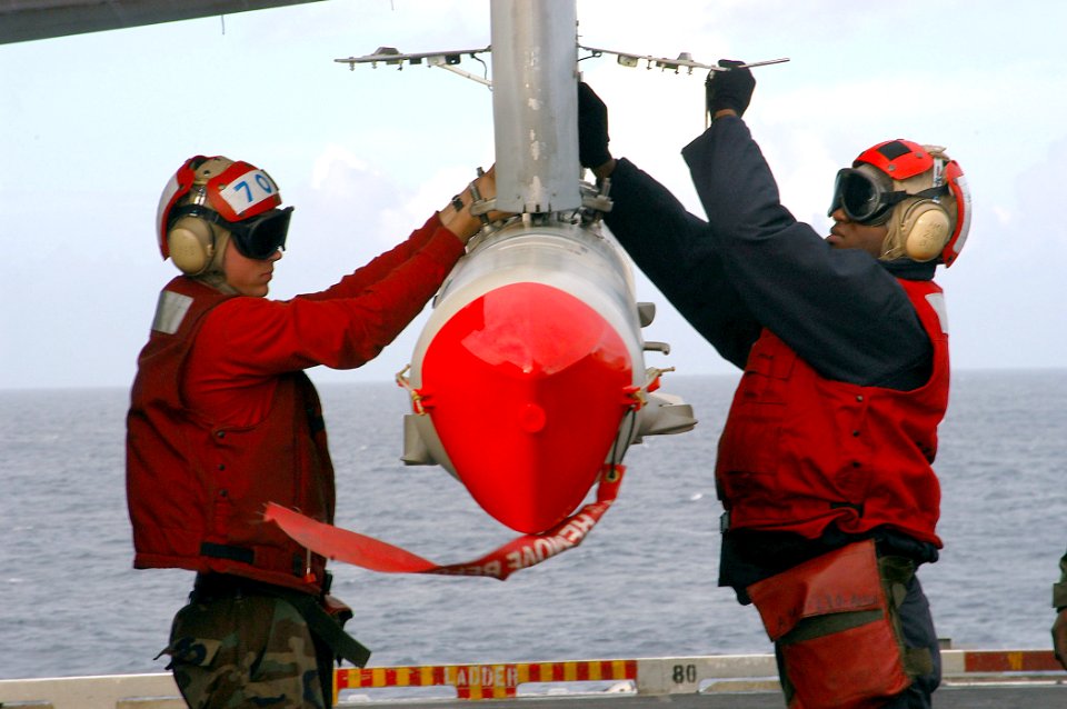 US Navy 040128-N-3986D-002 Ordnanceman attach a Standoff Land Attack Missile-Expanded Response (SLAM-ER) to an S-3B Viking