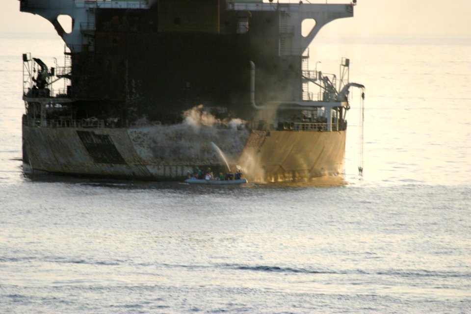 US Navy 040322-N-2060K-005 Sailors from the Pascagoula, Miss.-based Aegis guided-missile cruiser USS Yorktown (CG 48) fight a fire aboard motor vessel Everton off the coast of Oman