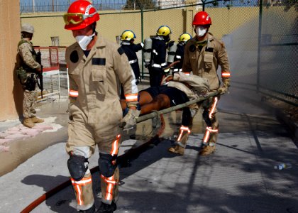 US Navy 040303-N-8955M-004 Emergency Response Team (ERT) personnel carry victims away from a simulated bomb explosion during Exercise Desert Sailor 2004 at Naval Support Activity Bahrain