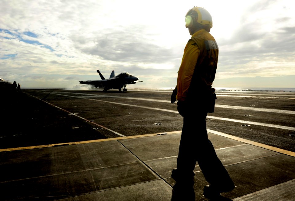 US Navy 110812-N-ZZ999-551 AB Taylor Maxwell prepares to signal an F-A-18F Super Hornet