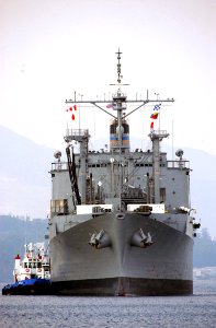 US Navy 040317-N-0780F-024 USNS Mount Baker (T-AE 34) is assisted by tugs as she arrives for a routine port visit at Souda Bay, Crete, Greece photo