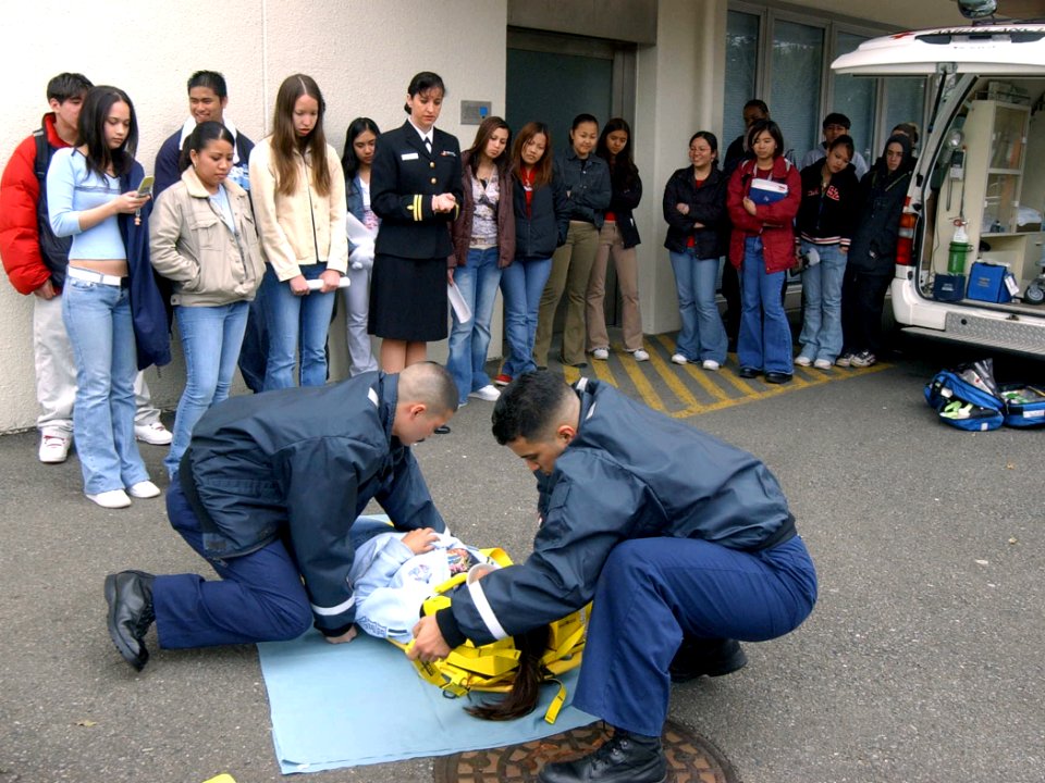 US Navy 040323-N-0000W-015 Hospital Corpsman Fernando Prieto and Hospital Corpsman Raulito Galgana demonstrate lifesaving techniques in the parking lot outside the Emergency Room of U.S. Naval Hospital Yokosuka, Japan