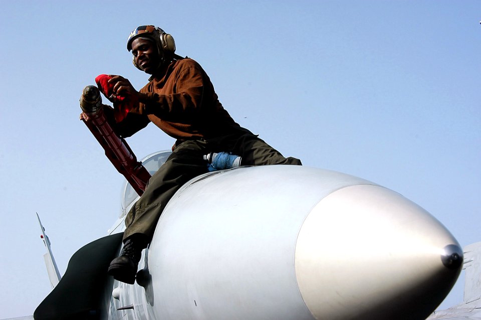 US Navy 040501-N-6278K-021 Plane Captain, Airman Miguel Butler of Selma, Ala., wipes down the in-flight refueling probe