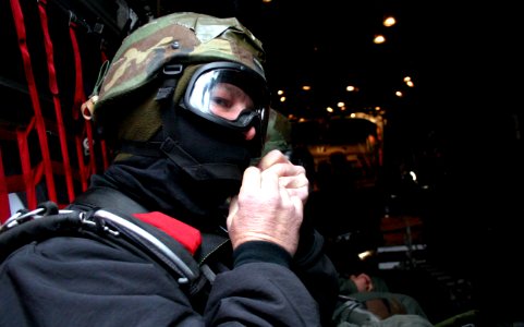 US Navy 040204-N-5821W-001 A member of Explosive Ordnance Mobile Unit Eight (EODMU-8) fixes his chinstrap before a freefall parachute jump