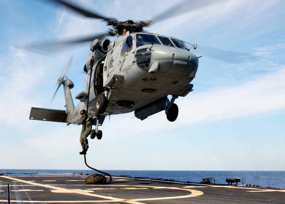 US Navy 040309-N-4374S-016 A Sailor assigned Explosive Ordnance Disposal Group Two (EODMU 2), Det. Four, performs a fast rope exercise from an HH-60H Seahawk assigned to the Red Lions of Helicopter Anti-Submarine Squadron One F