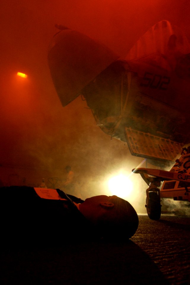 US Navy 040309-N-5319A-002 A sailor plays the role of a casualty member during an Improvised Explosive Device (IED) and Mass Causality exercise in the hangar bay aboard USS George Washington (CVN 73)