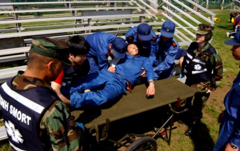 US Navy 040421-N-0000W-141 Hospital Corpsman 2nd Class Glenn Bagamaspad and Hospital Corpsman 3rd Class Emily Smyd prepare to transport a simulated casualty photo