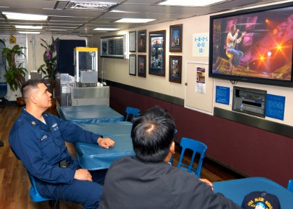 US Navy 040324-N-9860Y-045 Machinist's Mate 1st Class William Velasco, from Batanes, Philippines and a shipmate watch Velasco's daughter, Camile Velasco, 18, of Maui, Hawaii, perform her rendition of the classic song Desperado