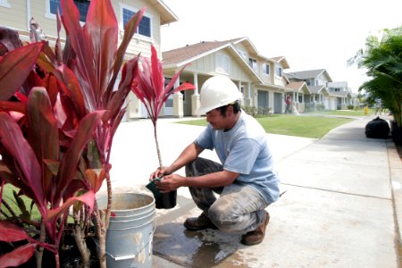 US Navy 040324-N-3228G-002 A landscaping contractor puts the finishing touches on lawns at the new Navy housing on Ford Island