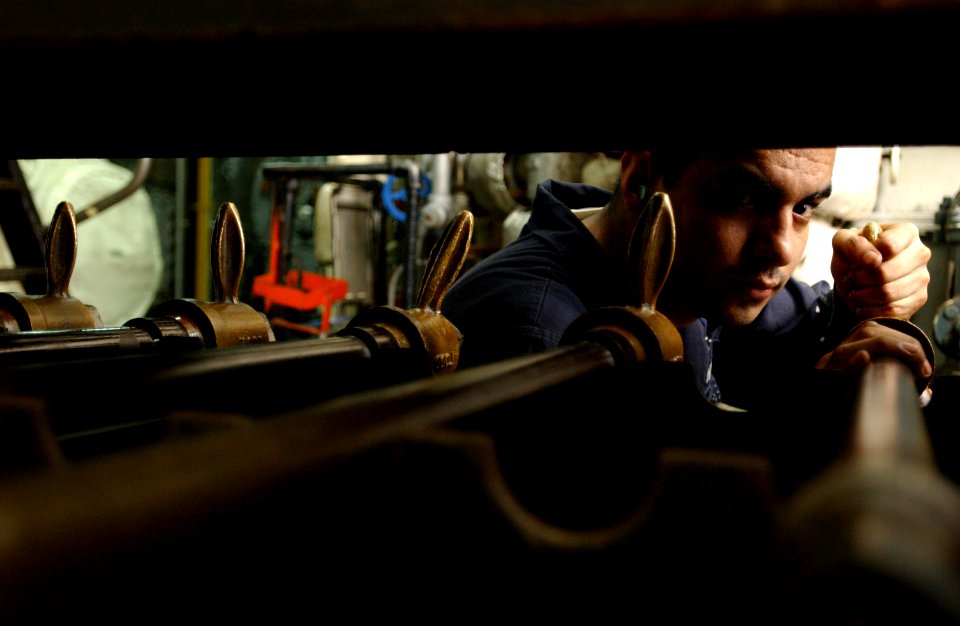 US Navy 040501-N-5821P-003 Machinist's Mate Fireman Israel Villalobos, of Beumont, Calif., adjusts machinery