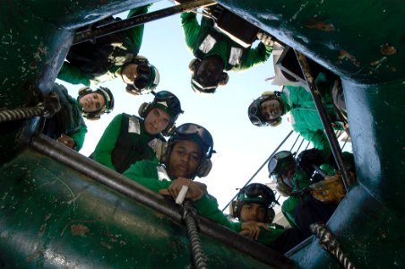 US Navy 040323-N-6653C-031 Air Department crew members listen to instructions given to rig the aircraft recovery barricade during a flight deck drill aboard USS George Washington (CVN 73)