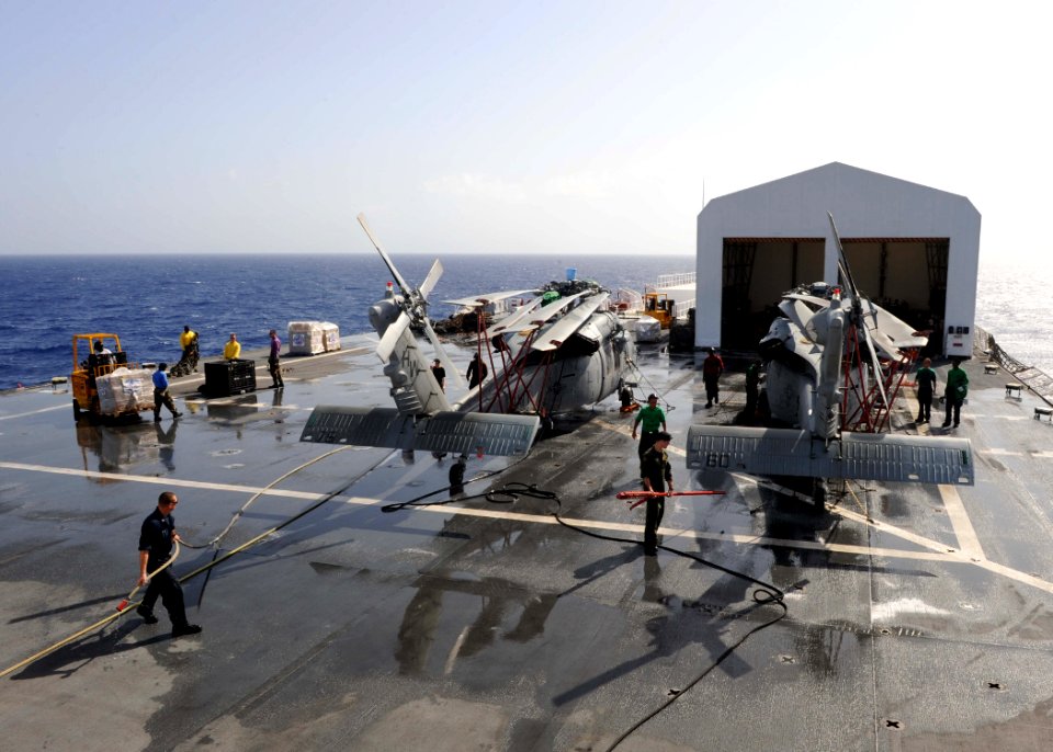 US Navy 110822-F-ET173-008 Sailors inspect a helicopter