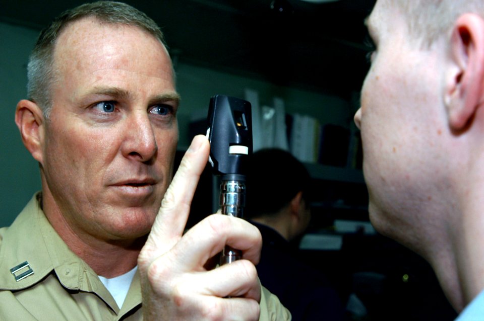 US Navy 040322-N-6278K-025 Lt. James Strafford, of Santa Barbra, Calif., examines a patient's eyes in the Medical Department aboard USS George Washington (CVN 73)