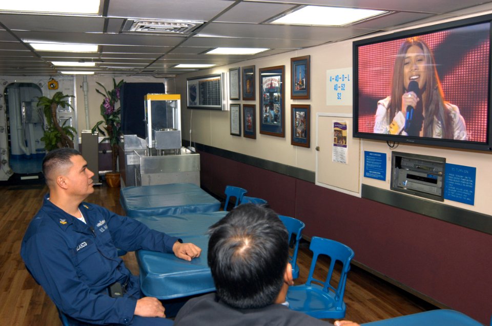 US Navy 040324-N-9860Y-043 Machinist's Mate 1st Class William Velasco, from Batanes, Philippines and a shipmate watch Velasco's daughter, Camile Velasco perform on the nationally televised American Idol