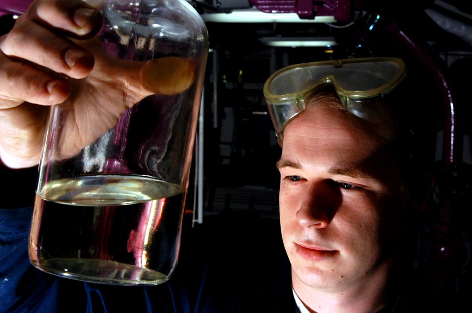 US Navy 040323-N-6278K-082 Airman Michael Hinshaw, of Pilot Mountain, N.C., inspects a sample of JP-5 aviation fuel in a pump room aboard USS George Washington (CVN 73)