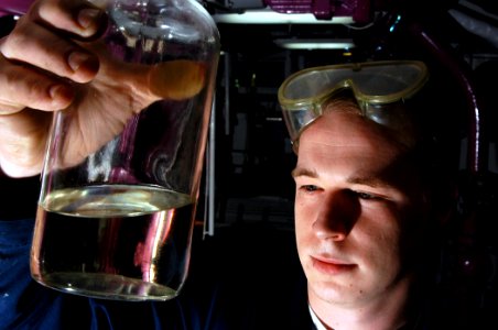 US Navy 040323-N-6278K-082 Airman Michael Hinshaw, of Pilot Mountain, N.C., inspects a sample of JP-5 aviation fuel in a pump room aboard USS George Washington (CVN 73)