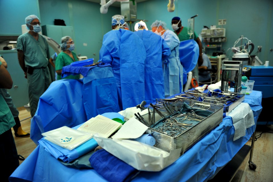 US Navy 110826-F-NJ219-212 Volunteer orthopedic trauma surgeons from Project Hope perform an operation on a Haitian patient aboard USNS Comfort (T