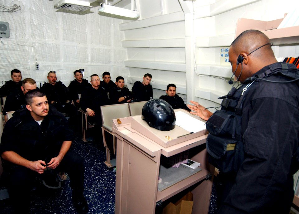 US Navy 040224-N-4374S-003 Members of the Vessel, Board, Search, and Seizure (VBSS) team assigned to the guided missile destroyer USS Roosevelt (DDG 80) conduct a safety brief prior to departing on a Maritime Interception Opera