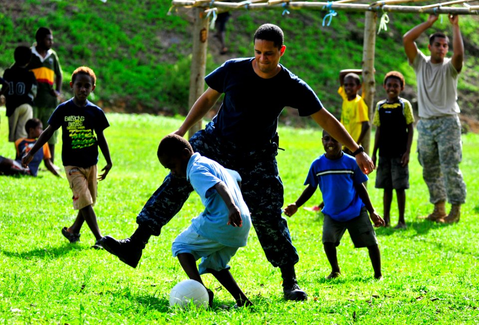 US Navy 110430-N-KB563-145 A Sailor plays soccer with local children during a community service project at Unity Park