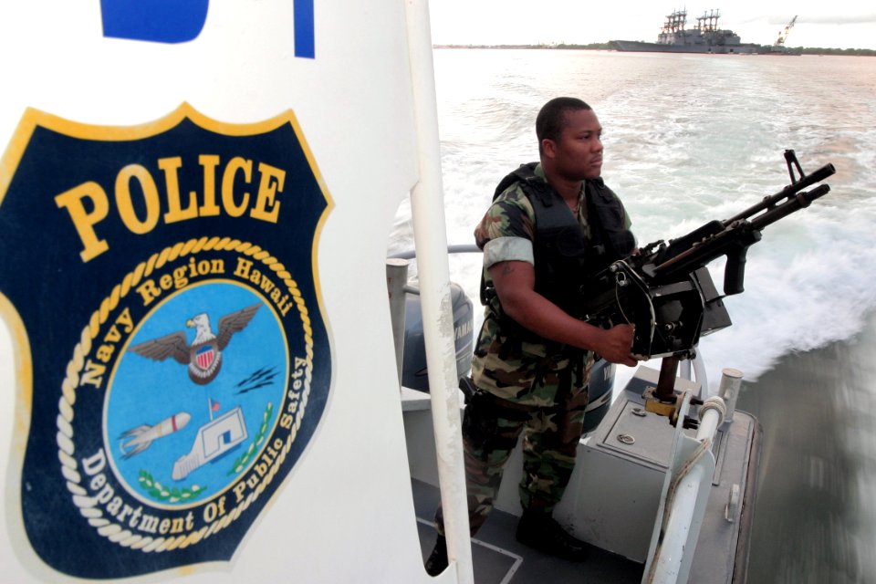 US Navy 040329-N-3228G-001 Master-at-Arms Seaman Ray Cowan, assigned to Naval Station Pearl Harbor Security, mans an M-60 machine gun aboard a 28-foot Sea Ark patrol boat