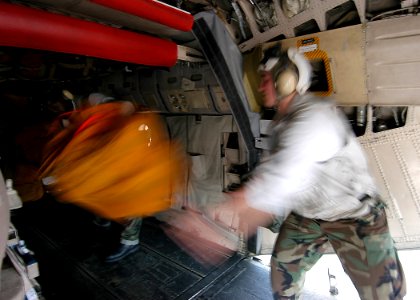 US Navy 040410-N-6278K-117 Crew members unload mail and supplies from a C-2A Greyhound