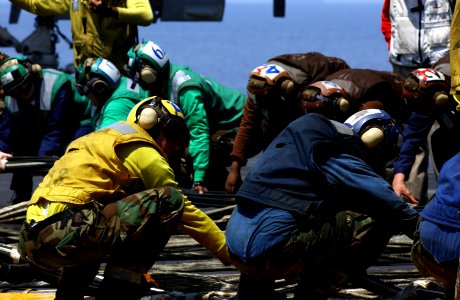 US Navy 040413-N-5821P-003 Sailors prepare to raise the emergency barricade during a flight deck drill aboard USS Kitty Hawk (CV 63)