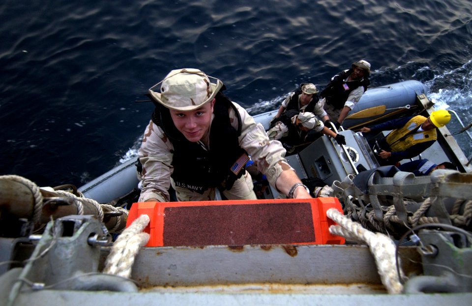 US Navy 040423-N-5319A-014 Hospital Corpsman 3rd Class Adam D. Snook, from Bellingham, Wash., climbs a pilot's ladder as the Visit Board Search and Seizure team (VBSS) assigned to USS Bulkeley (DDG 84)
