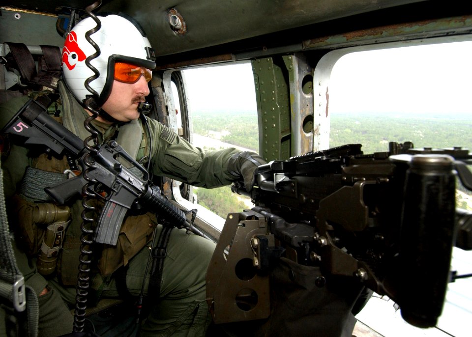 US Navy 040229-N-4374S-006 Aviation Warfare Systems Operator 2nd Class Wes Vinson, assigned to the Red Lions of Helicopter Anti-Submarine Squadron One Five (HS-15), monitors his surroundings for any visual contacts aboard an HH