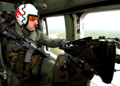 US Navy 040229-N-4374S-006 Aviation Warfare Systems Operator 2nd Class Wes Vinson, assigned to the Red Lions of Helicopter Anti-Submarine Squadron One Five (HS-15), monitors his surroundings for any visual contacts aboard an HH