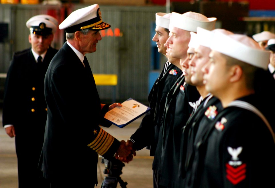 US Navy 040413-N-5821W-002 Adm. Gregory G. Johnson, Commander, U.S. Naval Forces Europe, presents awards to Sailors in Naval Air Station (NAS) Sigonella's Executive Transport Department (ETD) hangar