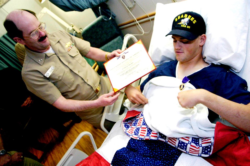 US Navy 040402-N-5321R-065 Rear Adm. Michael K. Loose, Commander, Naval Facilities Engineering Command and the Chief of Civil Engineers, presented the Purple Heart Medal to Equipment Operator Constructionman Leo