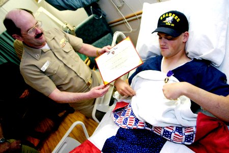 US Navy 040402-N-5321R-065 Rear Adm. Michael K. Loose, Commander, Naval Facilities Engineering Command and the Chief of Civil Engineers, presented the Purple Heart Medal to Equipment Operator Constructionman Leo