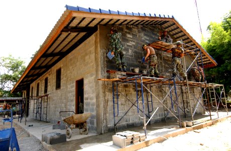 US Navy 040511-F-5855M-063 U.S. Navy Seabees assigned to Naval Mobile Construction Battalion Five (NMCB-5), Port Hueneme, Calif. and Thailand Army Soldiers work together to build a school in Ban Nam Yien, Thailand