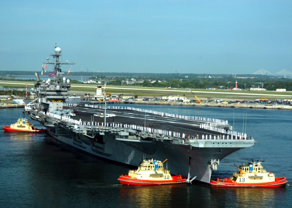 US Navy 040607-N-8704K-001 harbor tug guides the USS John F. Kennedy (CV 67) out of the Naval Station Mayport harbor