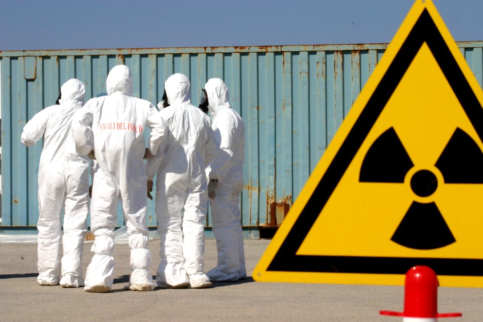 US Navy 040422-N-5821W-001 Italian firefighters dressed in chemical, biological, radiological (CBR) suits set up a perimeter of warning signs