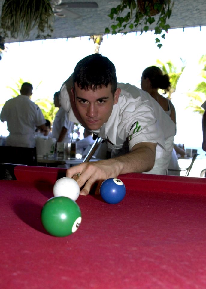 US Navy 040426-N-6268K-005 Airman John Madore from Oklahoma City, Okla., plays a game of pool on the Ft. Lauderdale's beach boardwalk