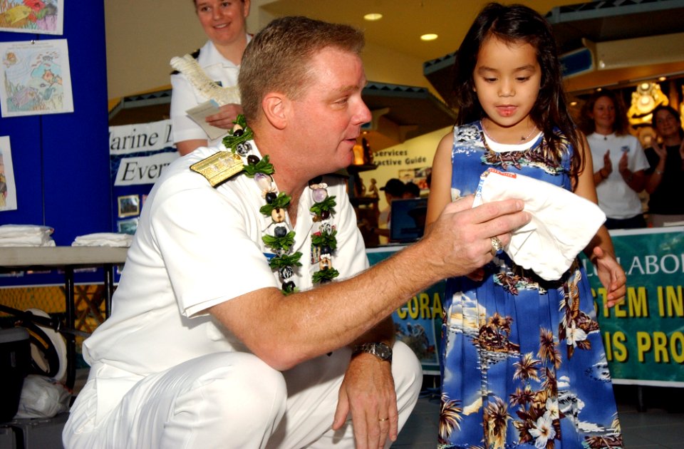 US Navy 040417-N-3019M-002 Rear Adm. Barry McCullough, Commander, Navy Region Hawaii, presents an award to one of the coloring contest winners as part of Earth Day celebrations