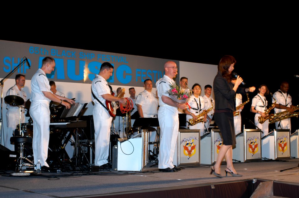 US Navy 040514-N-1194D-019 Sailors assigned to the Seventh Fleet Band's big band, Far East Edition, receive recognition from a Shimoda Black Ship Festival representative