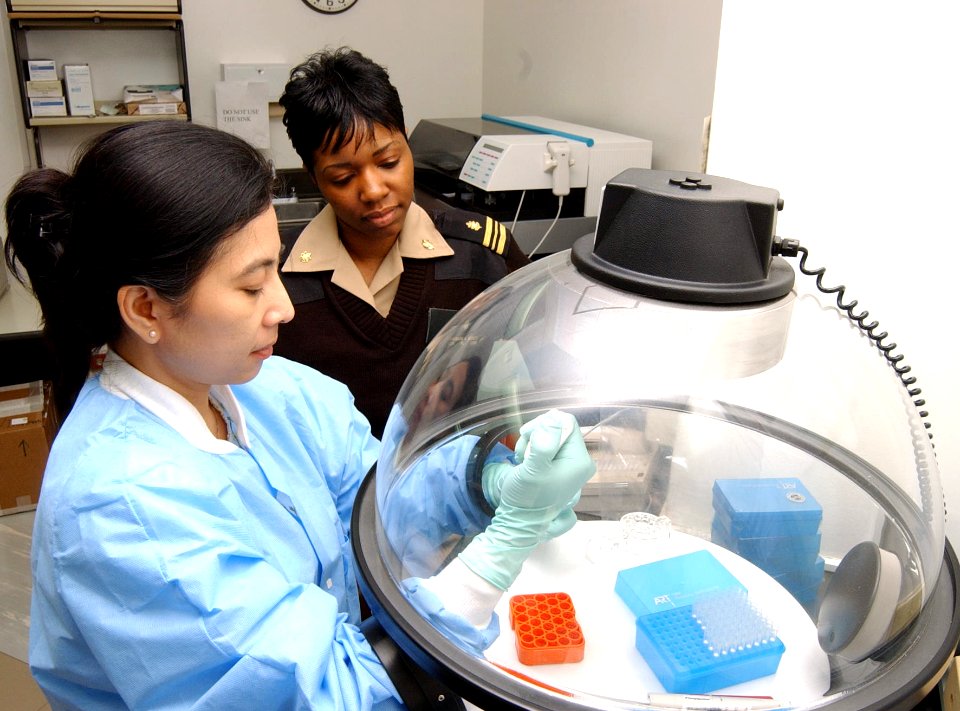US Navy 040427-N-0000W-027 Lt. Cmdr. Charmagne G. Beckett overseas a test conducted by civilian technician Erlin Listiyaningsih in the U.S. Naval Hospital (USNH) Yokosuka laboratory