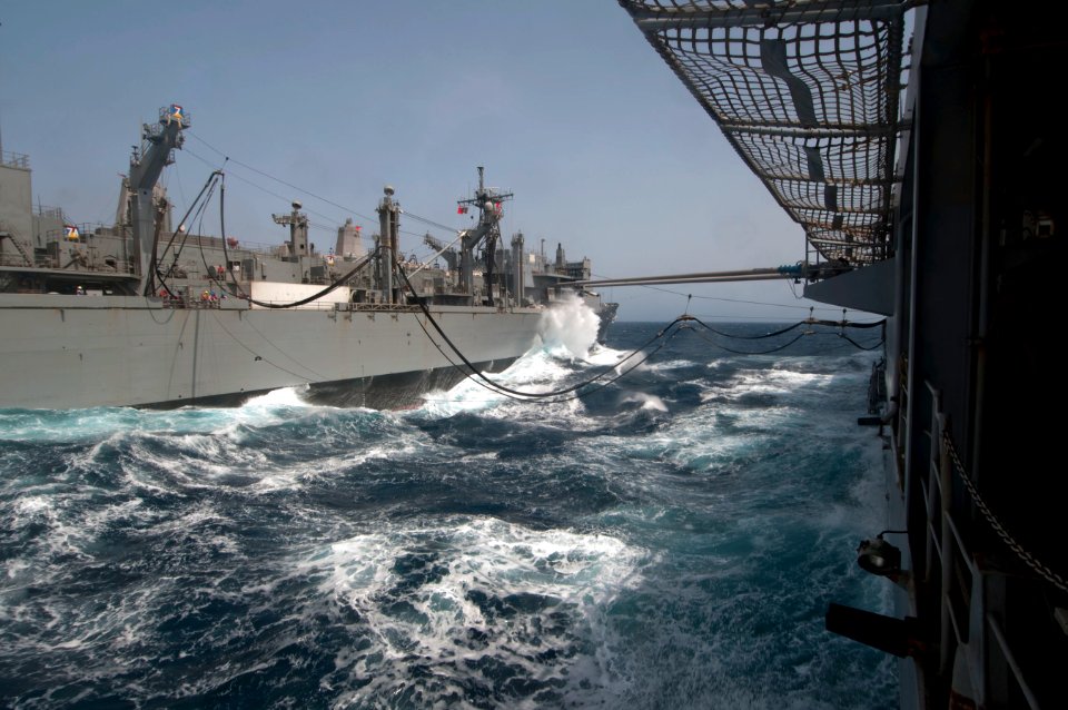 US Navy 110607-N-RC734-229 USNS Bridge (T-AOE 10), left, transits the Gulf of Oman alongside USS Comstock (LSD 45) during an underway replenishment