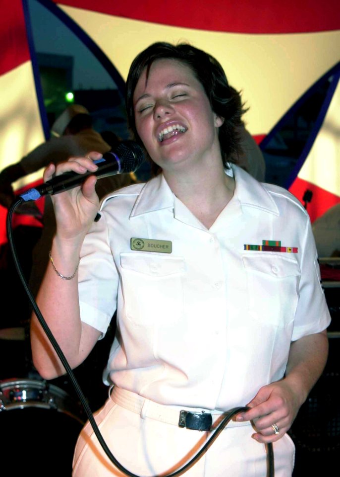 US Navy 040426-N-6268K-013 Musician 2nd Class April Boucher sings during a two hour concert