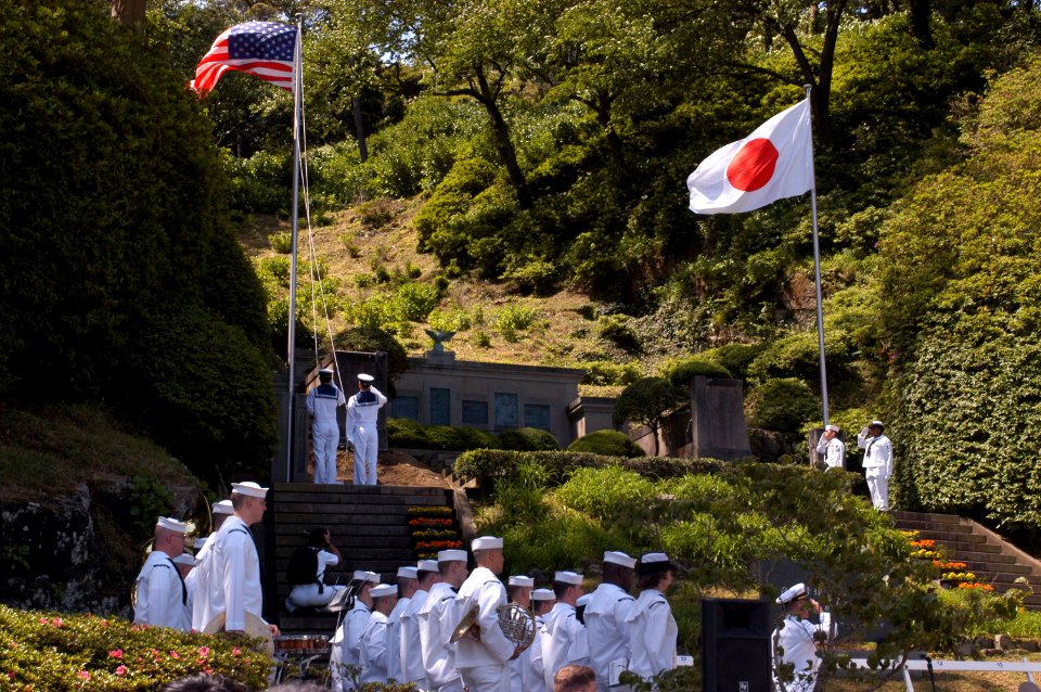US Navy 040515-N-1194D-003 Sailors render hand salutes and the U.S. Seventh Fleet Band stands at attention while Japan Maritime Self Defense Force Sailors raise the National Ensign